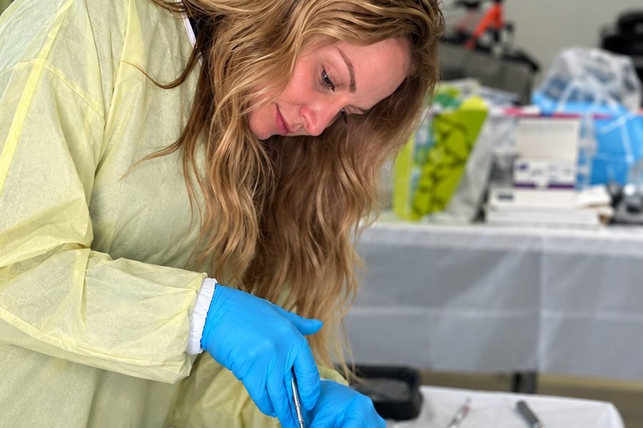 A participant performing an injection technique on a cadaver