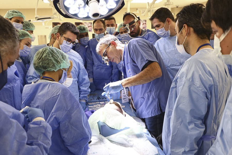A mentor demonstrating a procedure to participants during hands-on work